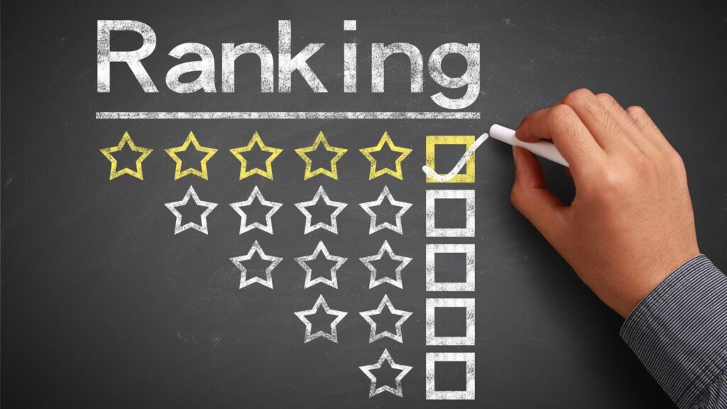 a hand checking neet exam ranking on a black board