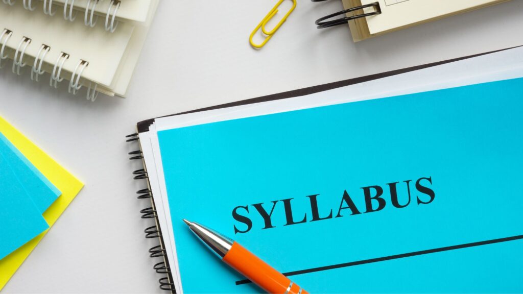 picture shows pen and note with the word syllabus on it